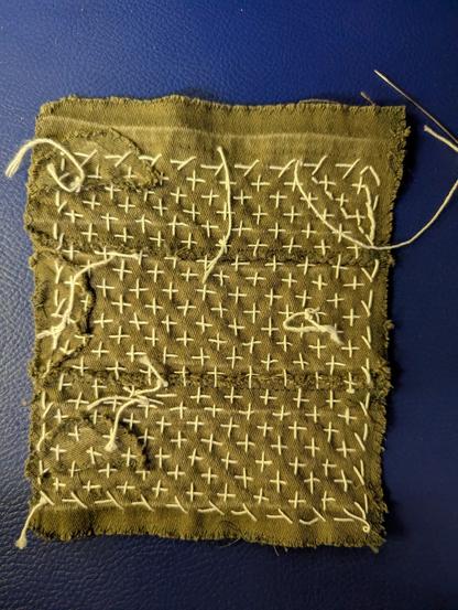 The back of the piece of fabric. There's also crosses, but also loose pieces of thread that have been knotted.
