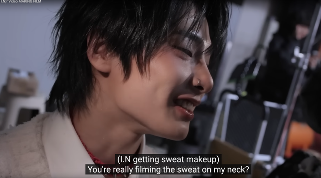 Side view of I.N, focusing on his neck. Caption: (I.N getting sweat makeup) You're really filming the sweat on my neck?