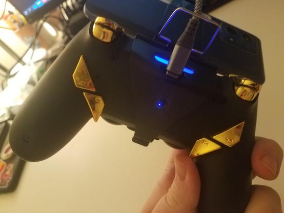 the back of the controller. there are extra buttons attached to the back, and a blue light showing through a hole cut into the phone grip.