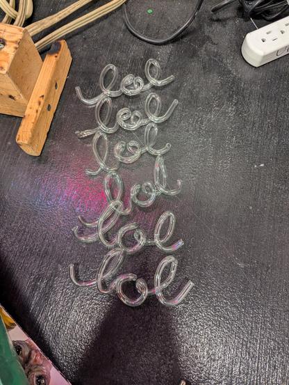 six lols against a black painted table, with their ends fire polished