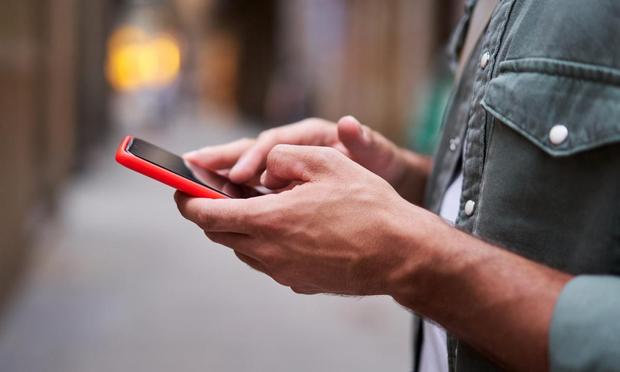 Una persona, con su teléfono móvil. (Getty Images)