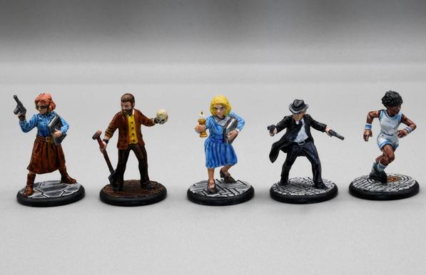 Five civilian figures on street bases, a badass librarian type in skirt, shirt, boots and sunglasses with a gun, a gardener with a skull and spade, a more conservative but very angry librarian in a dress with lace collar with a candlestick and a book, a private eye or gangster (or both) with a suit, a Stetson and two guns, an athlete armed with legging it