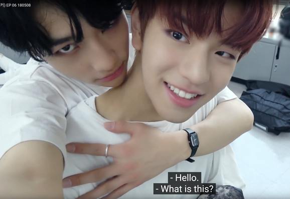 Hyunjin records a video of himself pulling a happy Seungmin back against his chest. Caption: "Hello." "What is this?"