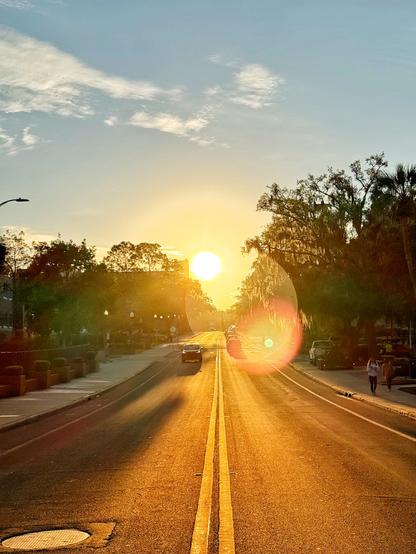 Sunrise looking down the center of a street.