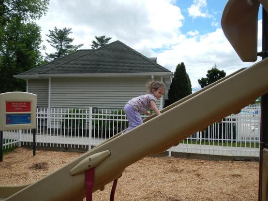 Luciana climbing the slide