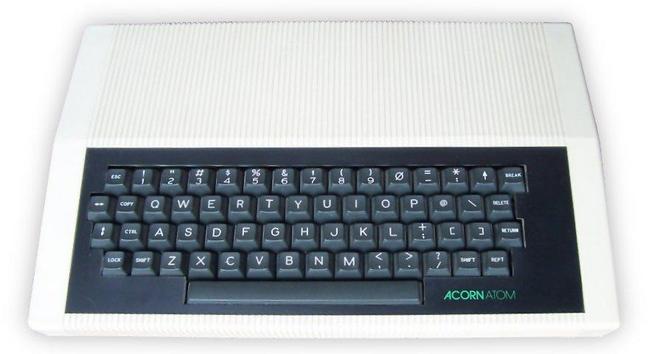 Photo of an Acorn Atom microcomputer. To me it looks like a dark-colored computer keyboard.