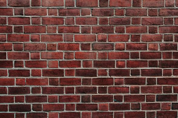 Photograph of a red brick wall. By Seyi Ariyo under a free Unsplash License: https://bit.ly/41LEkMS.