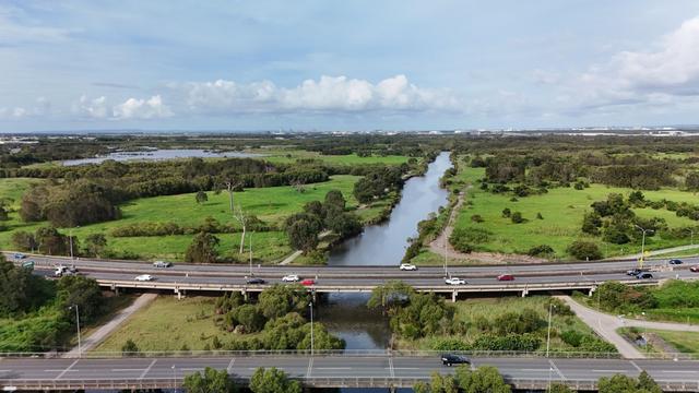 An aerial shot of Kedron Brook, looking out towards Kedron Brook Wetlands and the Brisbane Airport.