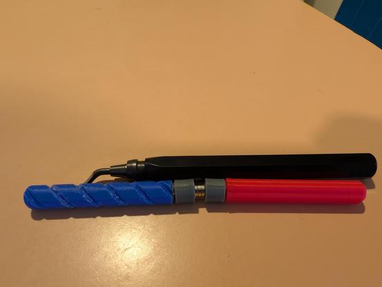 Two small tools for inserting magnets.
The left is blue and has a south polarity.
The right is red and has a north polarity.