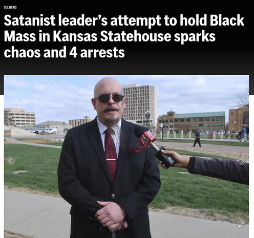 Headline: "Satanist leader’s attempt to hold Black Mass in Kansas Statehouse sparks chaos and 4 arrests" Image: Michael Stewart, the President of the Kansas City-area Satanic Grotto, speaks with reporters as the group’s rally gets started outside the Kansas Statehouse, Friday, March 28, 2025, in Topeka, Kansas. (AP Photo/John Hanna)