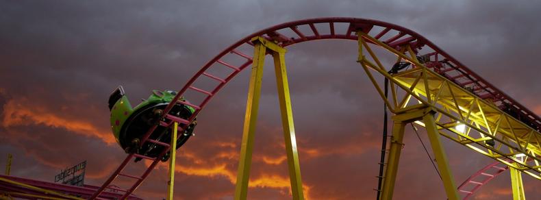 A story sky backdrops a lonely roller coaster car.