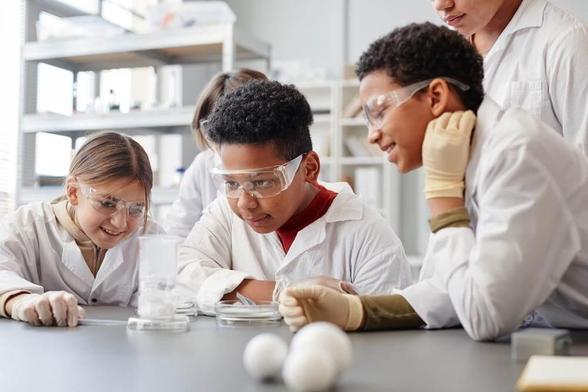 children smiling around a chemistry experiment
