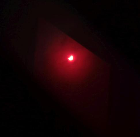another pink blob viewed through a floppy disc but this time it has a clear bite taken out of it