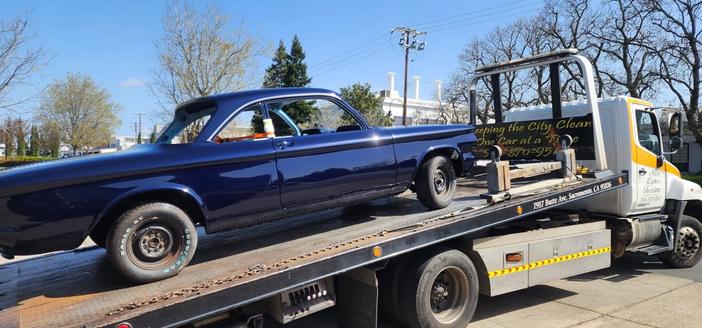 1964 Chevy Corvair Monza Coupe loaded onto transport for ride home after body restoration