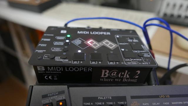 Bastl MIDI Looper with a Billlie "Back 2 Where We Belong" sticker on its front.