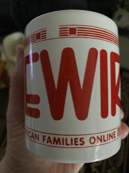 White mug with red writing “LIVEWIRE” and “American Families Online.”