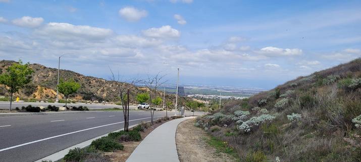 A view of the city and neighborhood below Blue Sky fluffy clouds