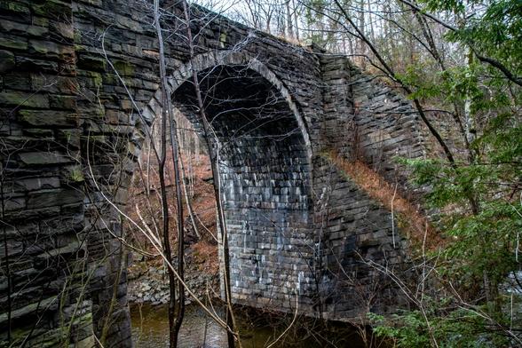 An large stone arch bridge over an river