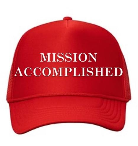 A red cap that says, "Mission Accomplished."