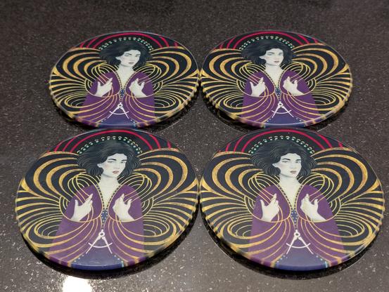 Four coasters featuring the 2025 Hedonism bottle art.