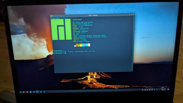 Bad picture of a computers desktop with only a terminal window open. The terminal shows the results of a neofetch.
