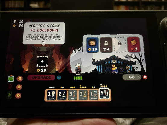 This screenshot from Shogun Showdown, played on a Steam Deck, shows the game’s shop. My deck is below, with several cards that have reached their full enhancement limit. For 20 of my 50 coins, I could buy an enhancement to one of my weapons that would increase to cooldown by 1, but would add Perfect Strike, where the attack’s cooldown would instantly recharge if it was used to remove the exact amount of HP the enemy had remaining. The shop also offers other items, enhancements, and permanent upgrades that can be purchased for various currencies.