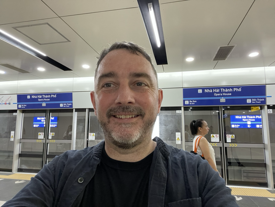 Middle aged man standing in front of platform doors at Met