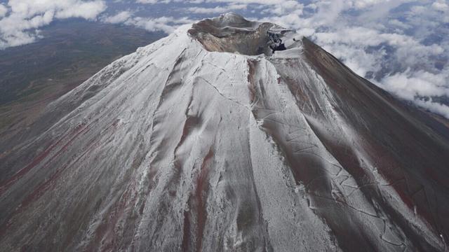 It's not official yet but Mount Fuji gets its trademark snowcap after the longest delay in 130 years