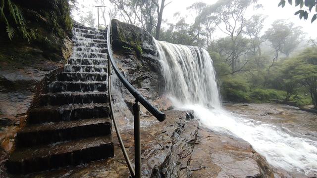 Sometimes even the trail is a waterfall! water cascading down cut sandstone stairs to the left. The waterfall on the right is just reclaiming some space