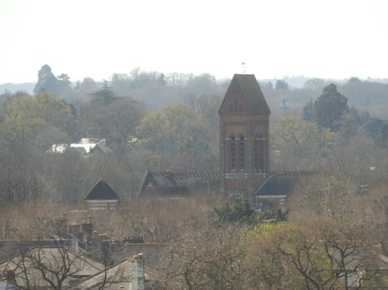 St Andrew's church in Surbiton. there's some more dramatic fading into the mist in this direction and the church appears to be mostly surrounded by trees, like a forest (at ground level is is not actually). at one mile away, the brickwork and bell vents are clearly visible