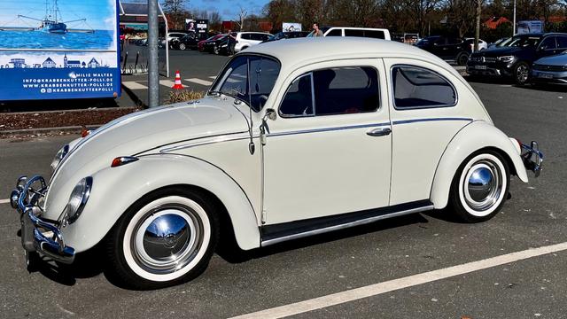 Photo Shows a light grey VW Beetle classic car.