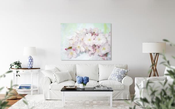 Soft pink cherry blossoms on a pastel blue and green canvas background in living room. The cherry blossom is symbol of spring, renewal, impermanence, and the fleeting nature of life and beauty.