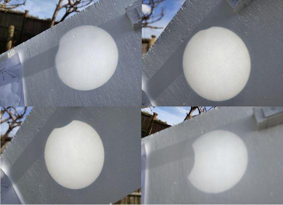 collage of 4 photos of the eclipse projected onto a white board from a small reflecting telescope