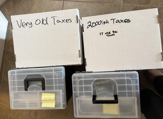 Two white cardboard document boxes. "Very Old Taxes" is written on one, "2000'ish Taxes" is written on the other.