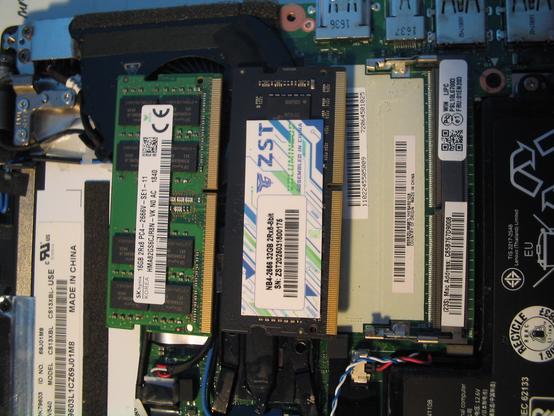 A Thinkpad X260 opened, showing the main board and the SODIMM memory slot. The 16 GB I just removed with the 32 GB SODIMM I am about to install is shown.