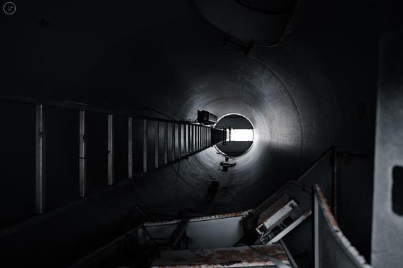 Shot up inside of wind turbine section showing ladder and scrap