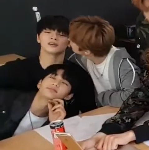 Lee Know attempts to kiss I.N, who is sitting next to him. Hyunjin is leaning sideways over I.N's lap