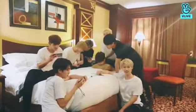 skz in a hotel room. Seungmin is bent over the bed clutching a pillow, with Chan standing behind him, possibly still leaning on him with some, erm, dick-to-butt contact happening. Changbin is leaning over Seungmin and has his hand in between Seungmin's shoulders. Felix is looking at the camera and the resolution is terrible but I'm imagining a look of amused disbelief and possibly internal panic.