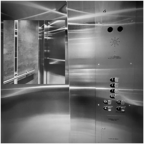 Black and white photograph features a close-up of an elevator interior. The control panel, made of stainless steel, occupies the right side, displaying floor buttons (3, 2, 1, M) alongside call buttons and etched instructions; "CALL ANSWERED." Reflective panels create overlapping patterns, capturing hallway and elevator details through distortions.