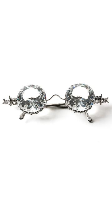 OPULENZ—the solid sterling silver eyeglasses with faceted cut gem lenses by innovative jewelry studio Xover0 rest folded on a white background.