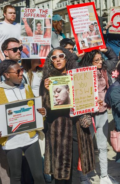 A group of people holding posters to raise awareness for TSW