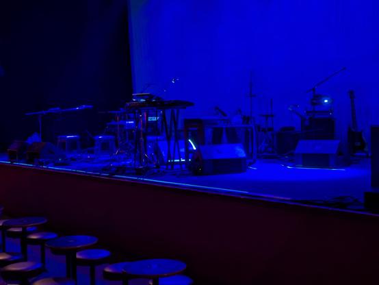 An empty stage bathed in blue light.