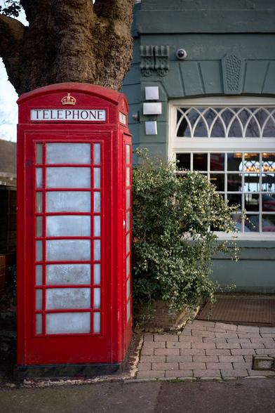 A bright red phone box outside a pub in Blackheath.
