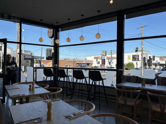 View across cafe tables onto a main road.