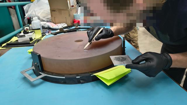 The M2 of the MONET telescope on a table while applying some glue.