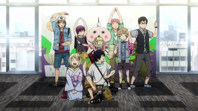 The whole cast dressed casual posing for a group photo