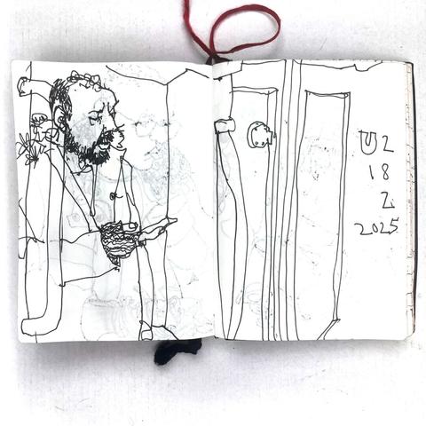 photo of a small sketchbook with a pen drawing from a berlin u-train