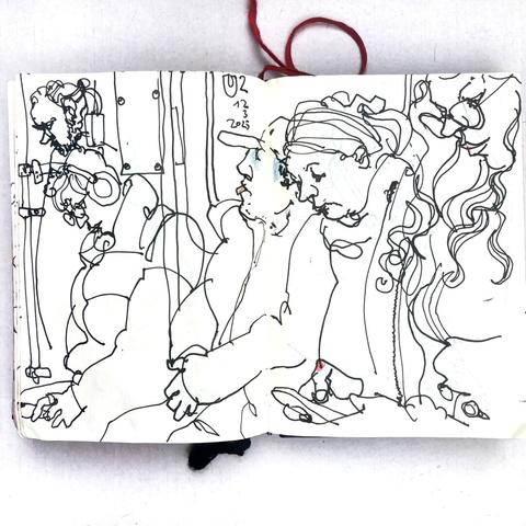 photo of a small sketchbook with a pen drawing from a berlin u-train
