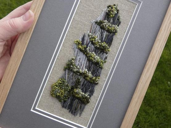 Same artwork held in the artist's hand for scale and viewed on an angle to show texture (image size 8x 20 cm