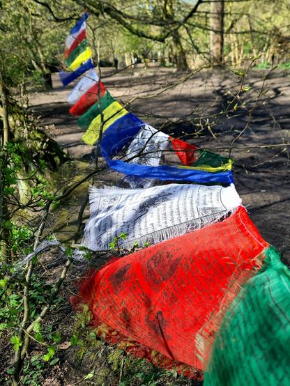 Tibetan prayer flags along the bank of a river in Glasgow.